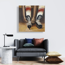 Canvas 24 x 24 - Hockey player ties his skates