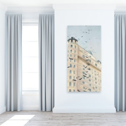 Canvas 24 x 48 - Birds flying in front of a building