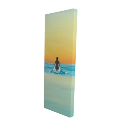 A surfer swimming by dawn
